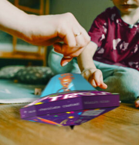 A hand spinning the Astro spinning top packaging redesign